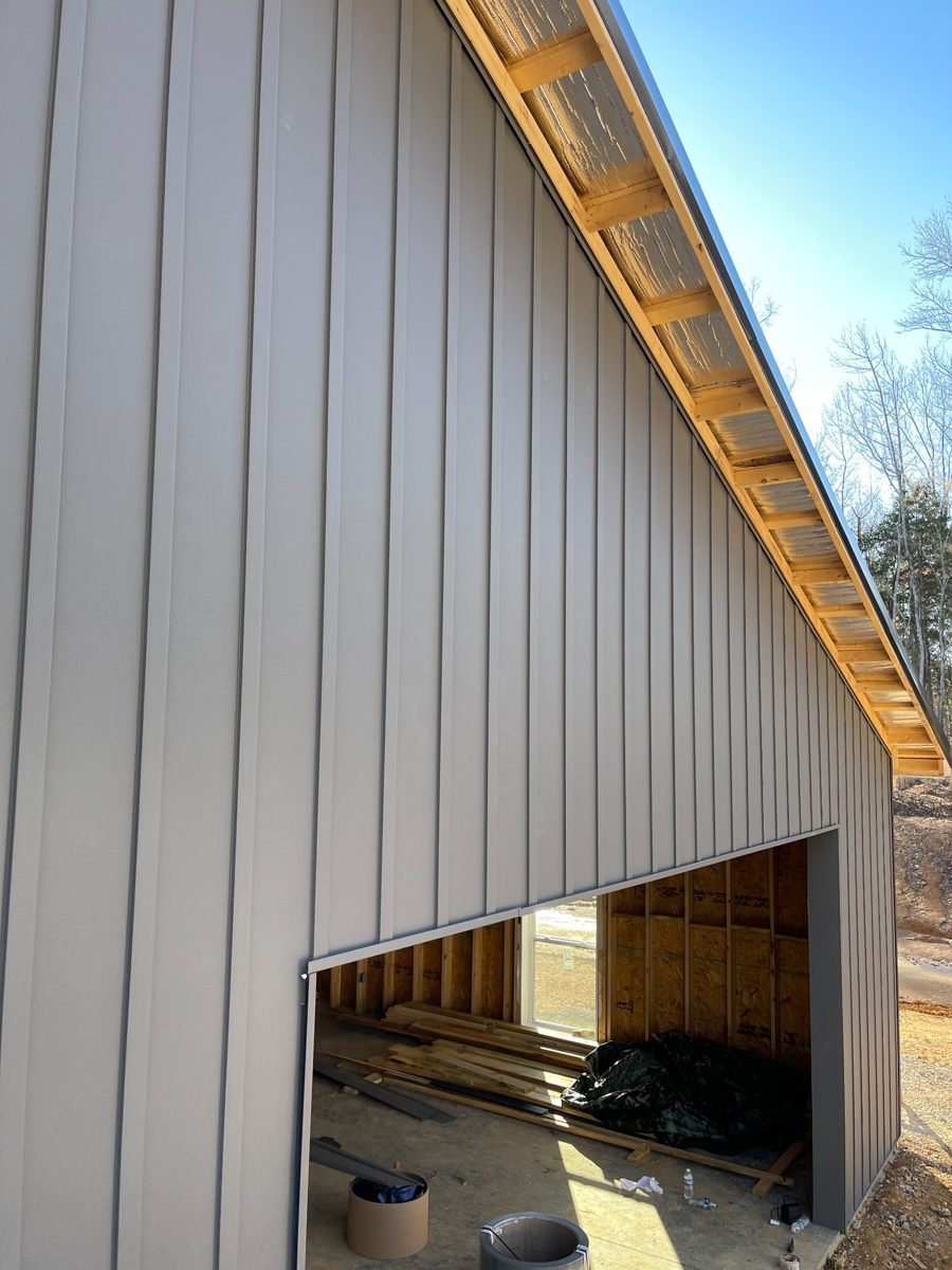 Close-up view of installed gray vertical metal siding