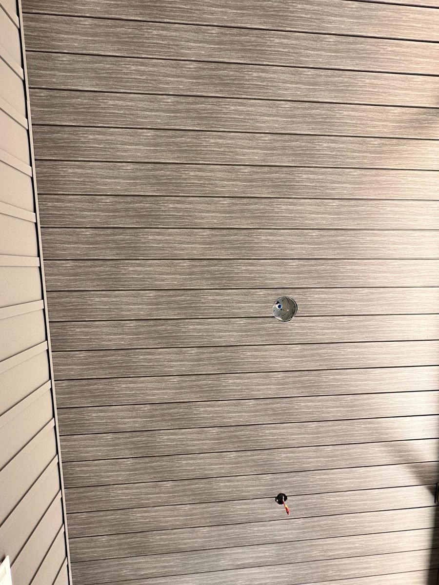 Close-up of woodgrain printed metal panel finish